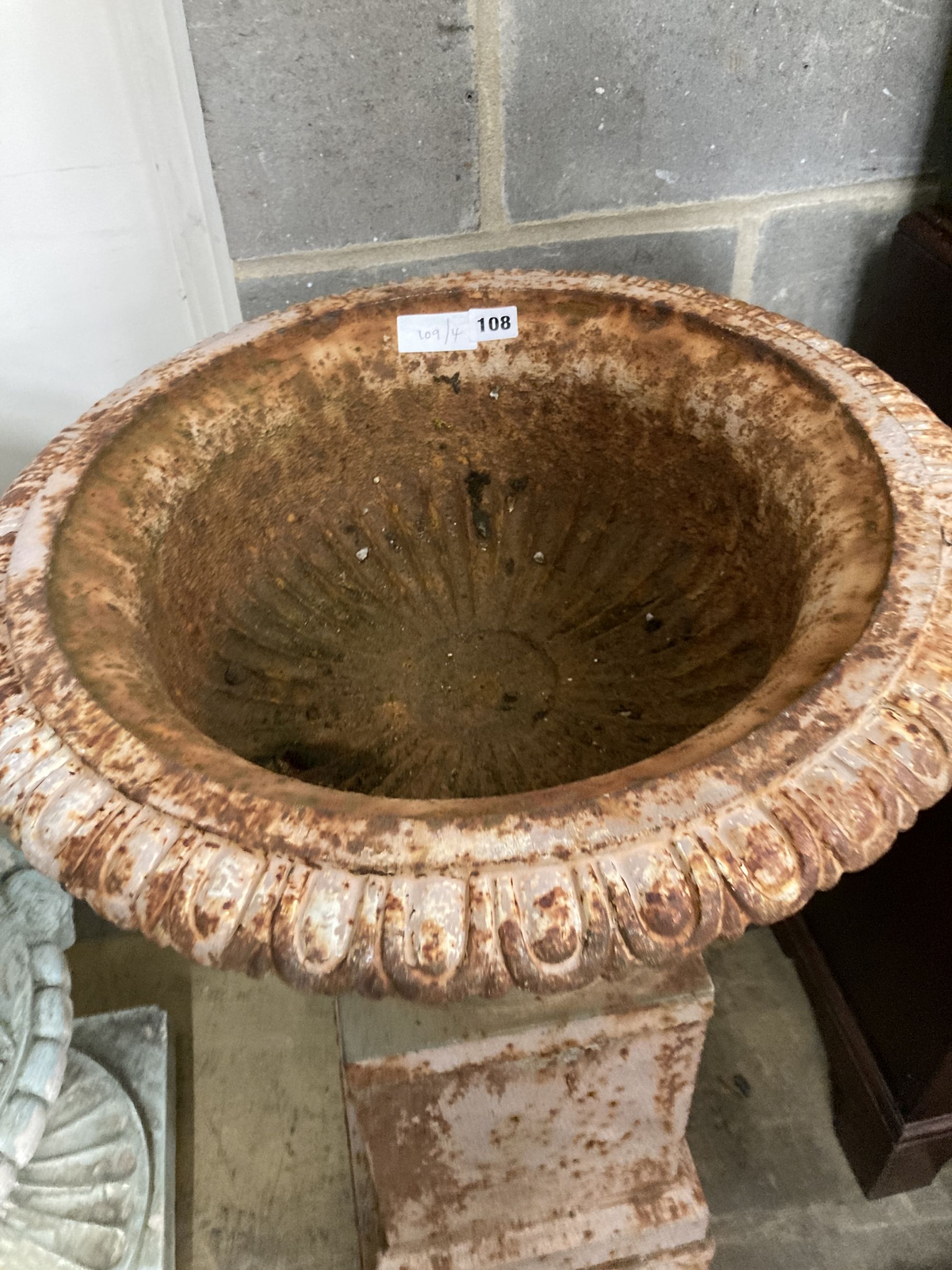 A Victorian style cast iron campana garden urn on stand, diameter 52cm, height 97cm